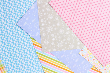 Paper background with winter design. Sheets of patterned paper for handmade New Year and Christmas ornaments, top view.