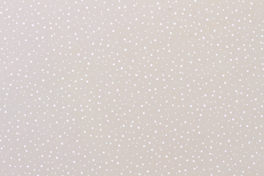 Grey paper background with a pattern of snow. Grey color texture pattern background. Paper for handmade winter craft.