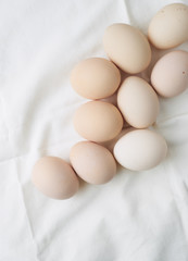 Fresh raw eggs in white background top view 