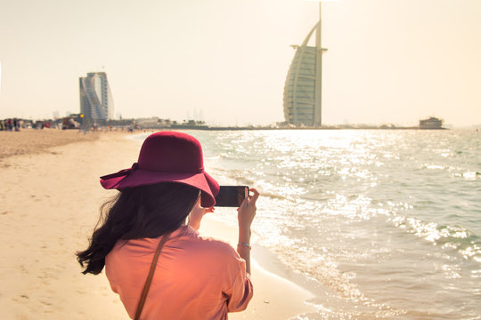 Girl taking picture at a famous beach in Dubai