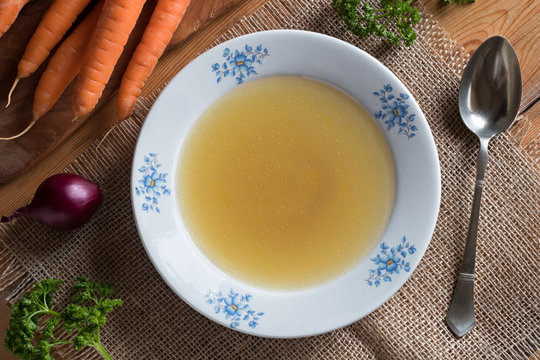 Chicken stock in a plate, top view
