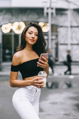 beautiful girl with phone in town