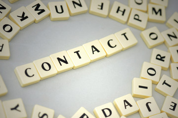 text contact on the gray background near the letters.