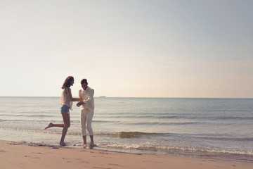 Young couple having fun on a sandy coast