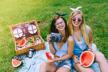 Two beautiful girls eating watermelon for a picnic