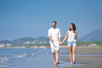 Young happy couple on white beach at summer vacation