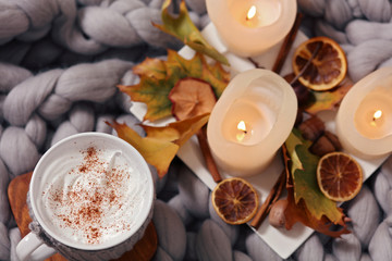 Cozy winter evening , cup of coffee, soft blanket, candles. Comfy lifestyle.