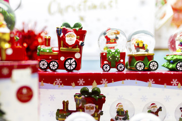 Christmas snow glove Santa Claus train ceramic ornaments on display in a shop window