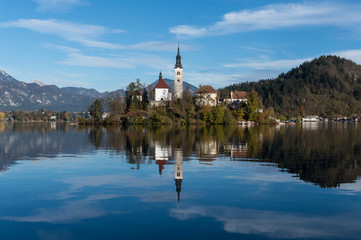 Fototapeta premium The church on the island in the middle of lake Bled reflecting perfectly in its waters