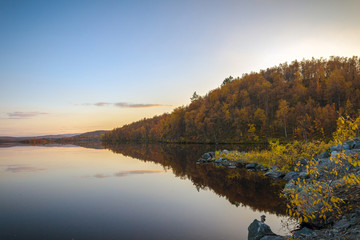 Naklejka na ściany i meble Autumn landscape.Lake in the autumn forest at sunset