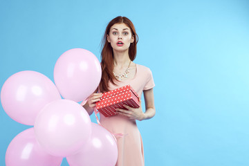 woman surprised, box, balloons, blue background