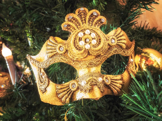 Venetian carnival mask on christmas tree. Christmas and New Year's background. Christmas tree, ball, candle, mask, Christmas decorations