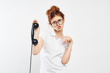 a girl in a white dress and a telephone receiver in her hand refuses to take a call