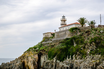 With a turquoise water in front the Lighthouse of Cudillero in Asturias is one of the most beautiful places in the North of Spain