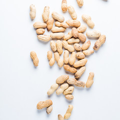 Raw peanuts on a white background