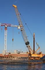 Fototapeta na wymiar crane of a yard on the seashore during the construction of a dam