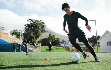 Foto op Plexiglas Soccer player practicing ball control © Jacob Lund