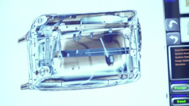Baggage is scanned in x-ray scanner. Operator change the modes of the scanner.