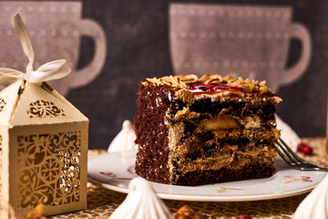 Piece of Chocolate cake with banana, walnut, meringue
