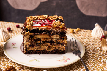 Piece of Chocolate cake with banana, walnut, meringue