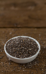 Chia seeds on dark wooden surface