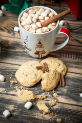 Hot chocolate with marshmallows on christmas decorated wooden table