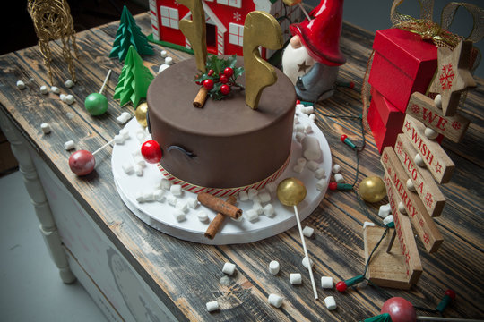 Christmas decorated chocolate cake on wooden table