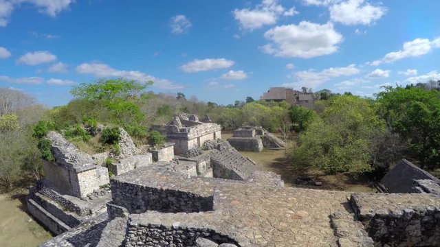 Gimbal shot of a woman sitting in mayan ruins in ek balam