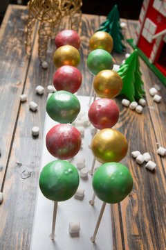 Cake pops on christmas decorated wooden table
