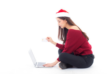 Young woman sitting labtop with internet shopping and holding credit card christmas holiday, girl shoping online on notebook in xmas, celebration concept.