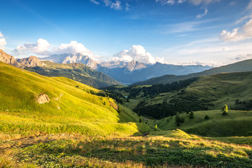 Fototapeta na wymiar Beautiful valley Val di Fassa near Canazei, Dolomites, Italy. View from Passo Sella. Marmolada glacier on the left in background.