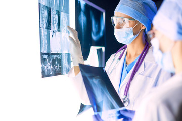 Two female women medical doctors looking at x-rays in a hospital