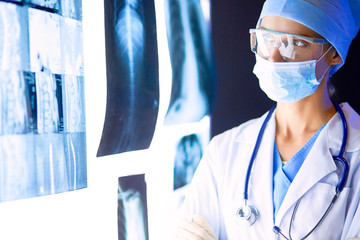 Image of attractive woman doctor looking at x-ray results