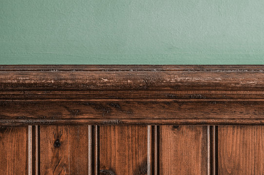 Old Wooden Skirting Board Against A Green Painted Wall Background Texture.