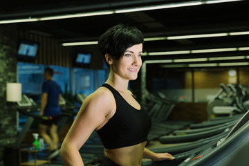 Fit healthy sporty woman doing cardio exercise on treadmill. Female athlete workout on stepper at...