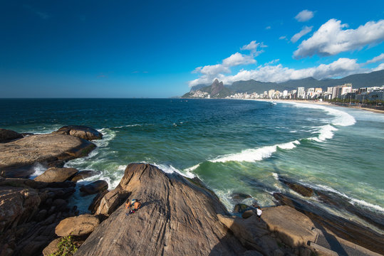 Scenic panoramic view of Ipanema Beach from the rocks at Arpoador with Rio de Janeiro skyline Brazil