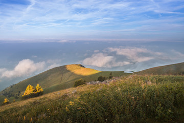 Fototapeta premium Mountain hut and pastures with lake Iseo onthe background, Brescia province, Lombardy district, Italy