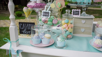 Details of a tasty candy bar with jugs of sweets, cookies and marshmallows, Candy, waffles, cookies...