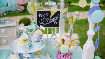 Details of a tasty candy bar with jugs of sweets, cookies and marshmallows, Candy, waffles, cookies...