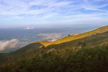 Mountain hut and pastures with lake Iseo onthe background, Brescia province, Lombardy district, Italy
