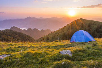 Camping outdoor with a tent with lake Iseo and Montisola at sunset, Brescia province, Lombardy...