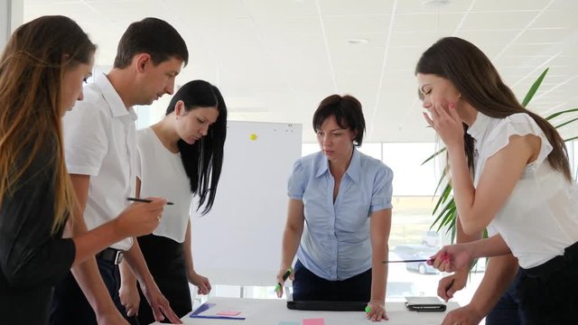office people beside desk discussing ideas business development in conference room at job