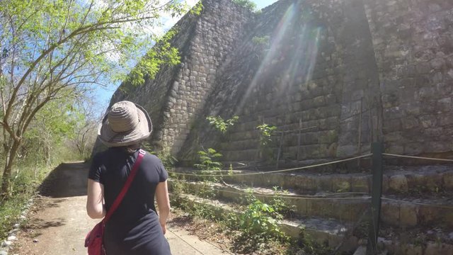 Gimbal shot of woman tourist walking at Ek Balam Mayan Ruins