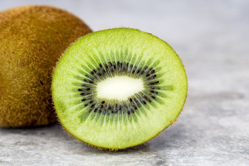 Half of juicy kiwi fruit on background.