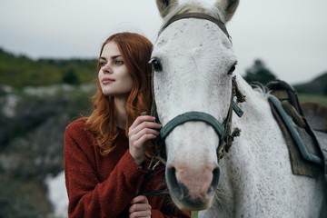 Obraz premium young woman with a horse walks on nature, travel, fresh air