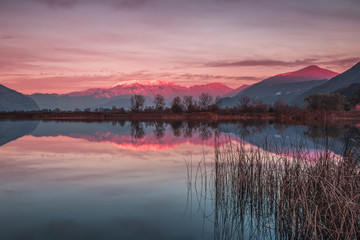 Fototapeta na wymiar Sunset in Torbiere del Sebino with mount Guglielmo reflection, Nature Reserve, Iseo, Brescia province, Lombardy district, Italy, Europe