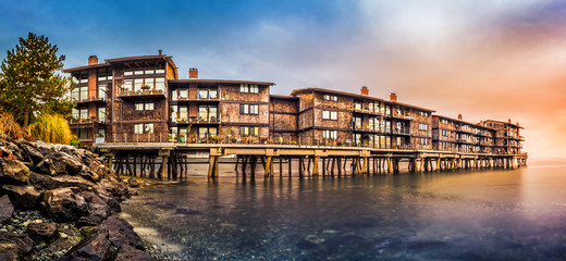 Panorama with stilt houses in West Seattle neighborhood at sunset``