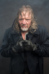 Obraz premium Older man in cold fog with long coat. Cyberpunk theme.