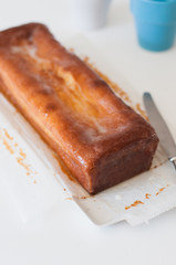 Freshly baked and homemade lemon pound cake or Madeira cake with lemon sugar icing on white table