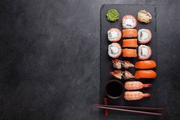 Sushi Set sashimi with salmon, shrimp, eel and sushi rolls philadelphia served on stone slate. Top...